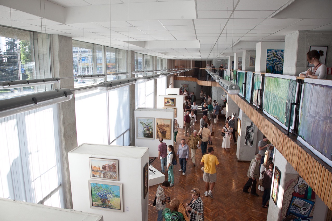 Visitors viewing paintings at an art exhibition